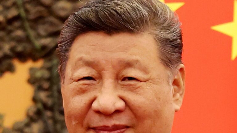 Retrato de Xi Jinping, líder chino, sonriendo en un evento oficial.